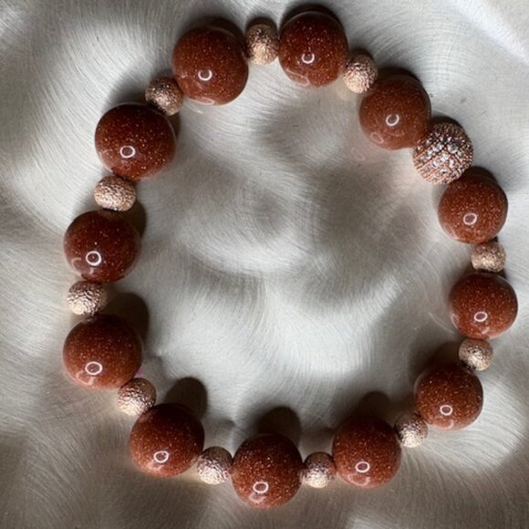 bracelet features large, polished goldstone beads - Picture 1 of 3